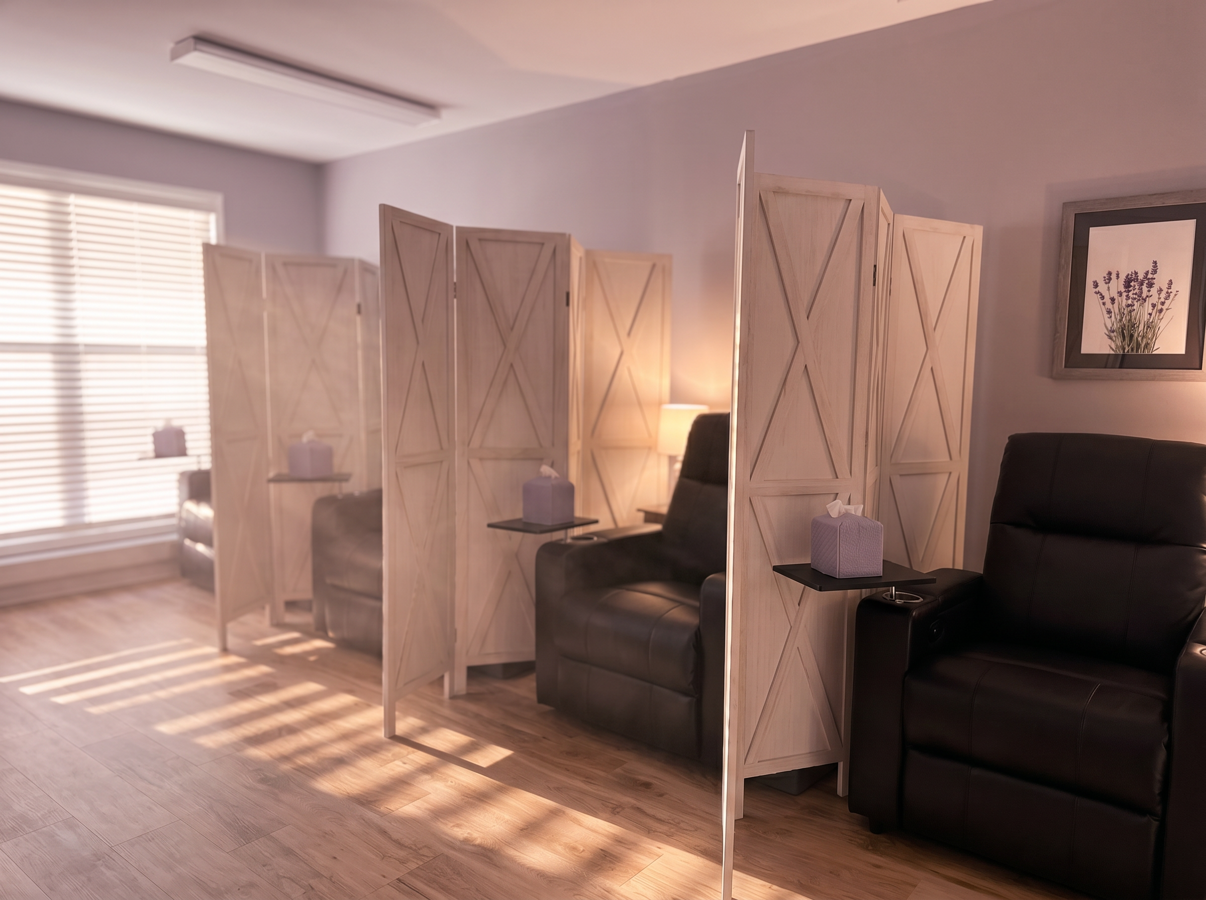 Three semi-private Spravato® treatment suites with modern black recliners in a calm, softly lit space.